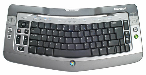 Microsoft Wireless Entertainment Desktop 7000 keyboard with curved layout, glossy silver trim, and multimedia keys.