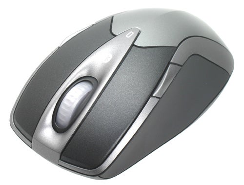 Microsoft Wireless Entertainment Desktop 7000 mouse with silver and black design, featuring scroll wheel and ergonomic side buttons.