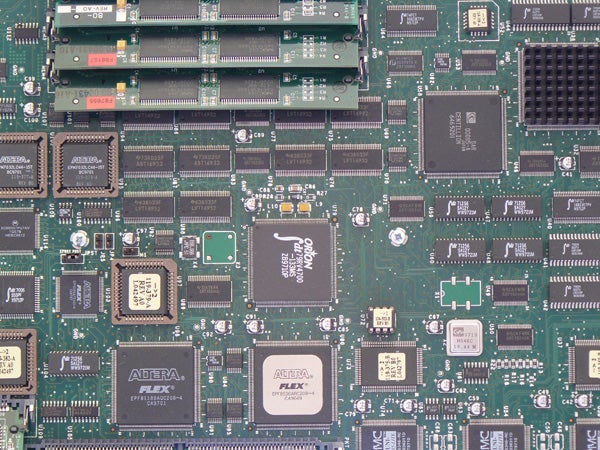 Close-up of a green circuit board with various integrated circuits, capacitors, and memory modules, representative of internal electronics, not specifically related to the Panasonic Lumix DMC-FZ8 camera.