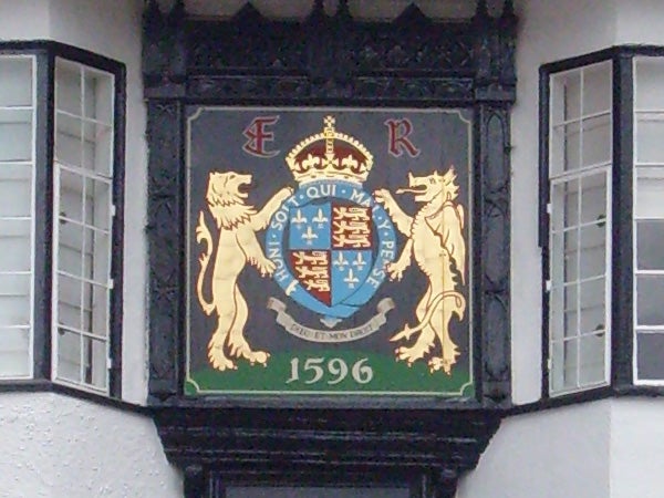 Historic coat of arms on building facade with date 1596.