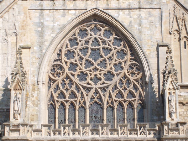 Intricate gothic window architecture of a cathedral.