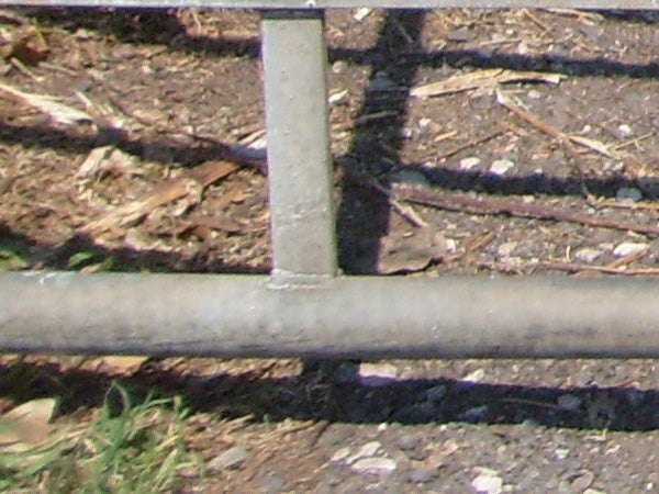 photo of a metal fence and shadows.