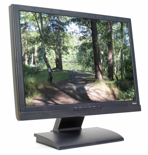Evesham Solar 8600 GTS monitor displaying a crisp image of a forest trail with trees and a person riding a bicycle in the distance.