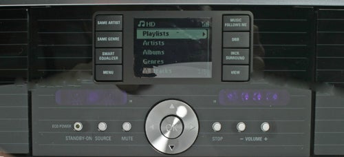 Philips Streamium WACS7000 music center close-up showing its display screen with 'Playlists' highlighted and control buttons including a central dial.