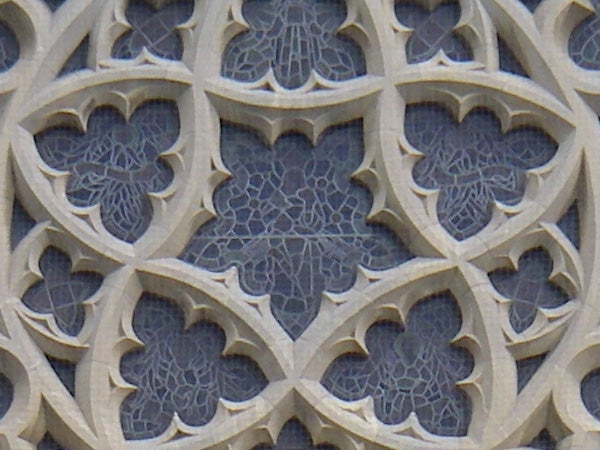 Close-up photo of a detailed stone carving with gothic-style floral patterns from the Pentax Optio W30 camera's perspective, demonstrating the camera's macro capabilities.