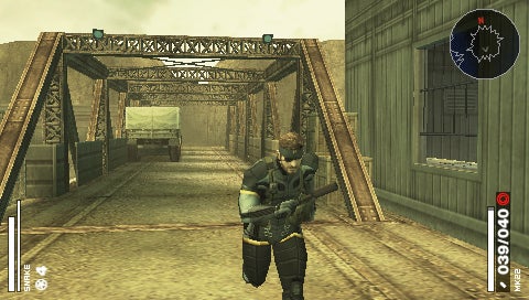 In-game screenshot from Metal Gear Solid: Portable Ops showing a character crouching with a rifle on an industrial metal bridge with a vehicle in the background and game interface elements displayed around the perimeter of the image.