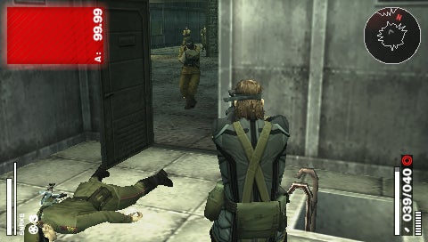 Screenshot from the video game Metal Gear Solid: Portable Ops showing a character in a green uniform sneaking up on an enemy guard inside a gray industrial facility, with game HUD elements displayed on the screen including health and ammo indicators.