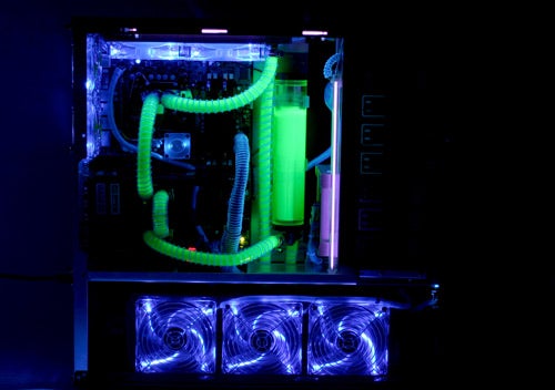 Illuminated custom PC with neon green cooling system.