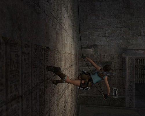 Lara Croft character climbing a wall in Tomb Raider: Anniversary game.