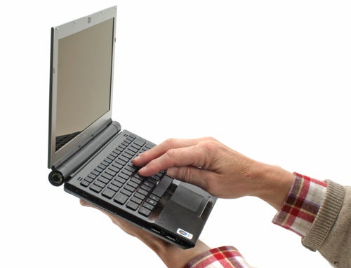 Person holding open Sony VAIO VGN-TZ11MN laptop.