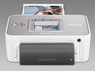 Canon Selphy CP750 compact photo printer with battery pack.
