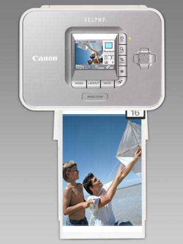 Canon Selphy CP750 printer with printed photo of two people.