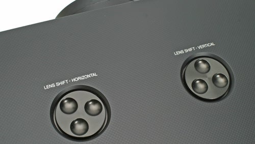 Close-up of Panasonic projector's lens shift controls.
