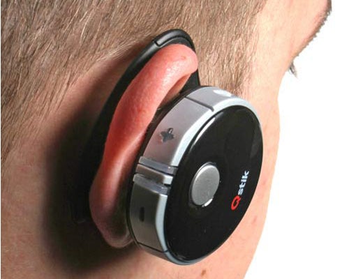 Qstik EVOQ Bluetooth Headset worn on person's ear.