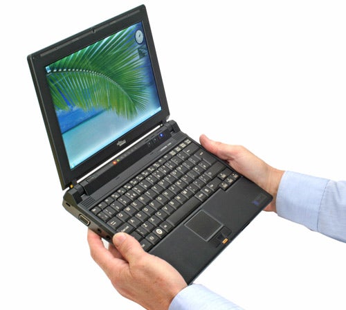 Person holding open Fujitsu Siemens Lifebook P7230 laptop.