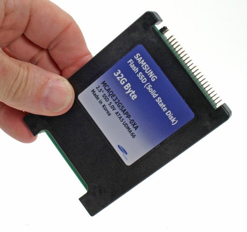 Hand holding a Samsung 32GB Solid State Drive