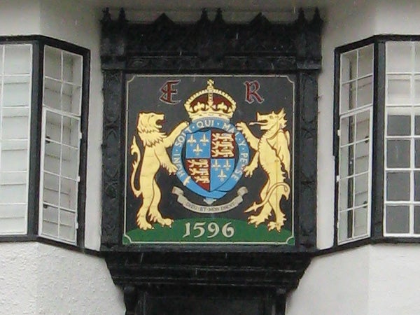 Coat of arms plaque on a Tudor-style building from 1596.