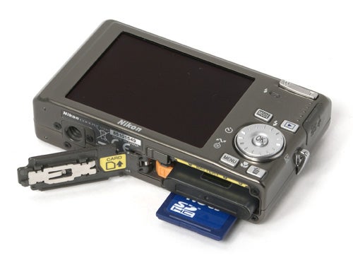 Nikon CoolPix S500 camera with open battery compartment.
