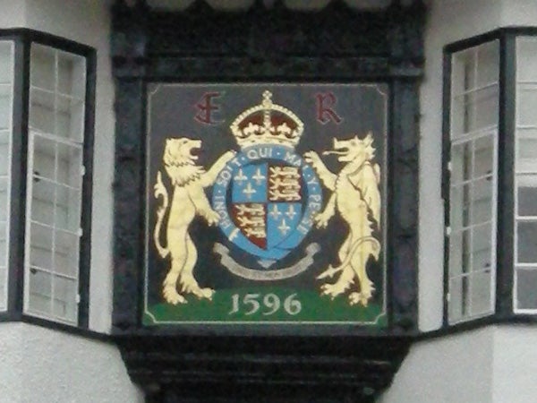 Blurry photo of a crest with lions, crown, and date 1596.