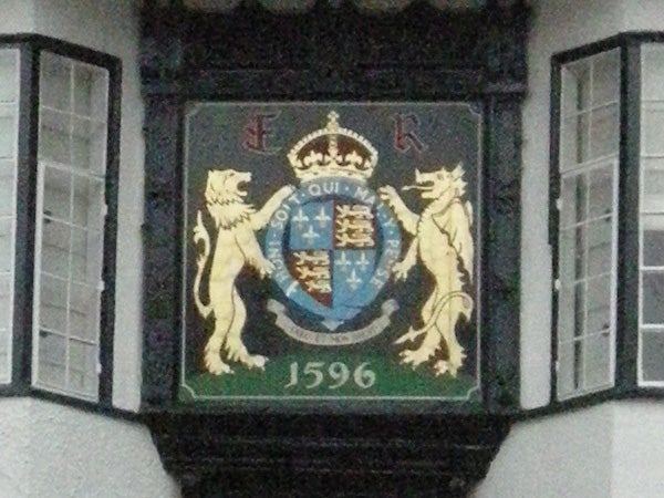 Coat of arms on a wall with two lions and a crown.