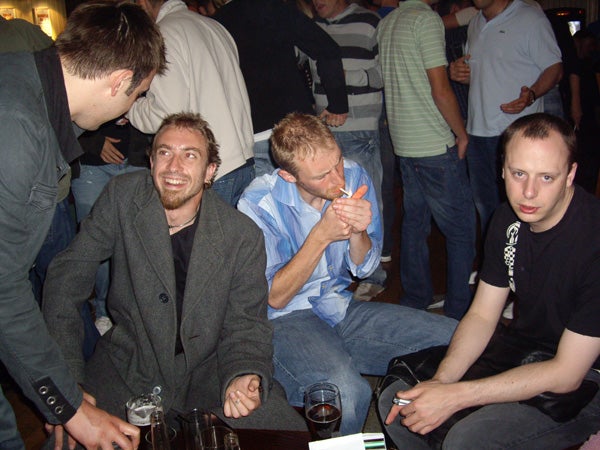 Group of people socializing in a bar setting.