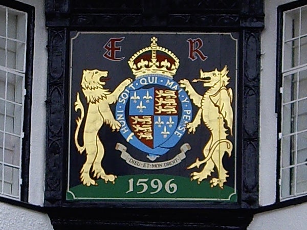 Coat of arms plaque dating back to 1596 on a wall.