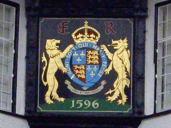 Coat of arms plaque with crown, lions, and date 1596