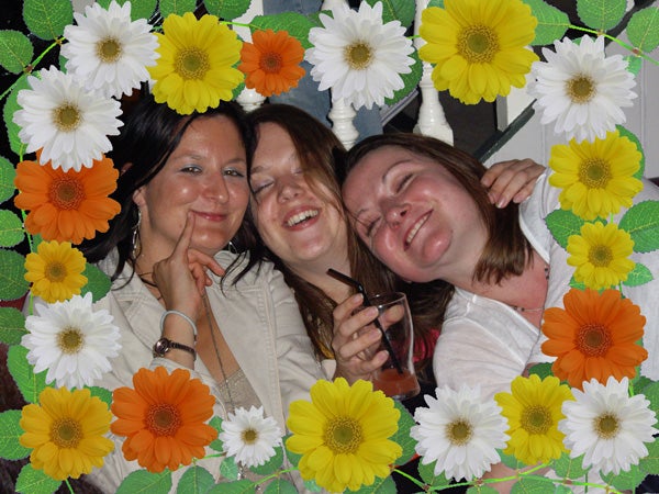 Photo of three smiling women with a floral border.