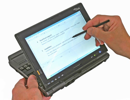 Person using stylus on Fujitsu Lifebook P1610 tablet PC.