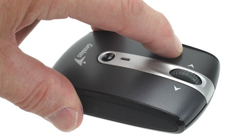Hand holding a Genius Traveler 915 Laser Mouse.