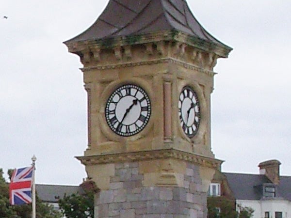 Historic clock tower with overcast sky background.