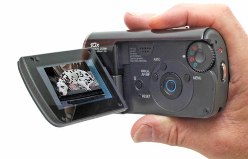 Hand holding Panasonic SDR-S10 Camcorder with flip-out screen.