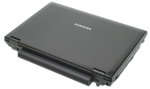 Closed Samsung laptop on white background.
