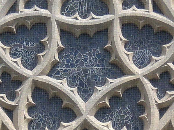Close-up of the intricate stone filigree on a building facade.
