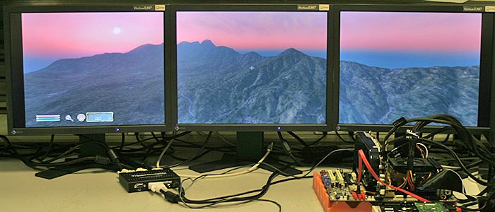 Matrox TripleHead2Go with triple-monitor setup displaying landscape