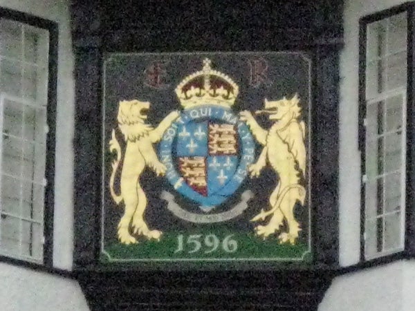 Blurry photo of a coat of arms plaque taken with Canon IXUS 75.