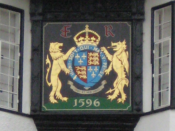 Coat of arms with lions on building facade.