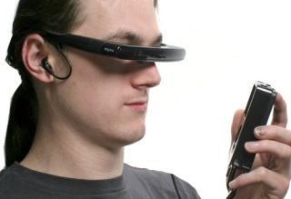 Person using Myvu Personal Video Viewer connected to a handheld device