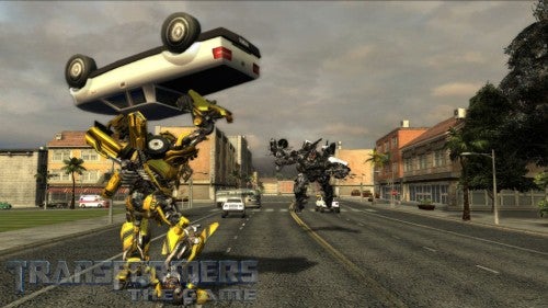 Transformers characters in combat on a city street from the game.