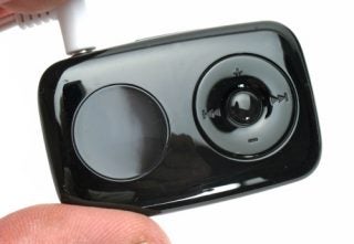 Close-up of Creative Zen Stone Plus mp3 player with earbuds.