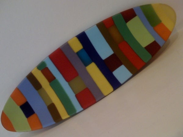 Colorful abstract skateboarding deck on white background.