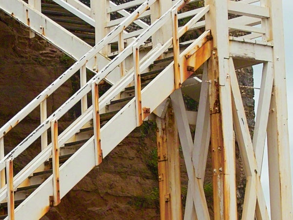 Wooden and metal roller coaster structure close-up.