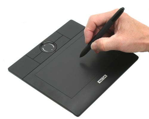 Hand using a Wacom Bamboo Graphics Tablet with stylus.