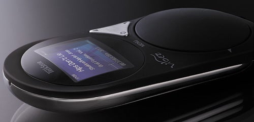 TrekStor vibez MP3 player with illuminated display on dark background.