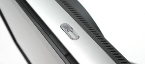 Close-up of HP w2207 monitor's power button and bezel detail.