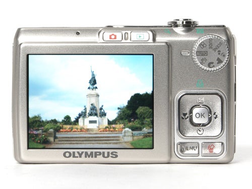 Olympus FE-230 digital camera with displayed photo on screen.