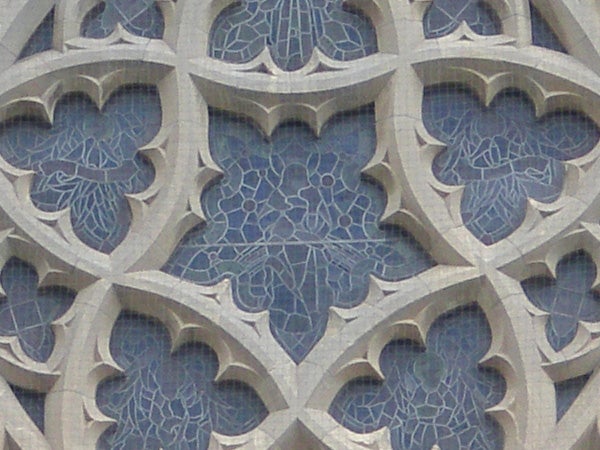 Close-up of architectural stone details with blue patterns.