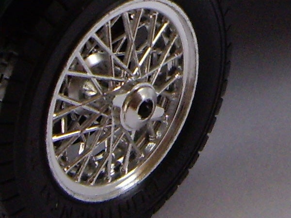 Close-up of a car wheel with a complex spoke design