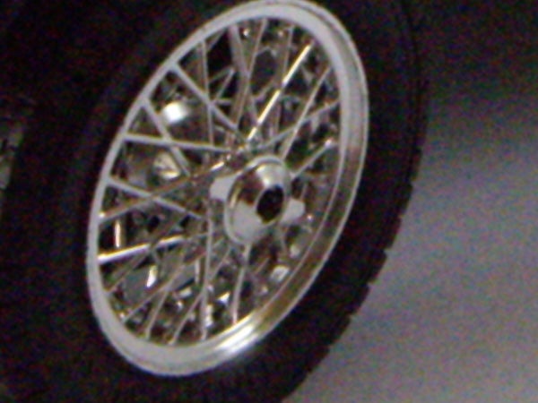 Close-up of a car wheel with a spoked rim.