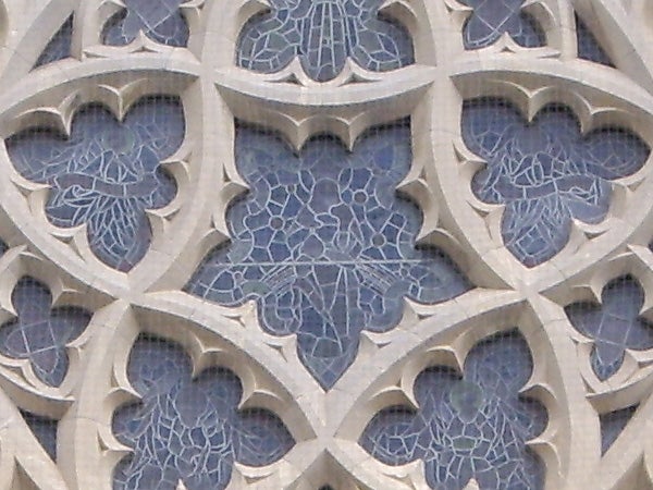 Close-up of intricate stone tracery on gothic architecture.